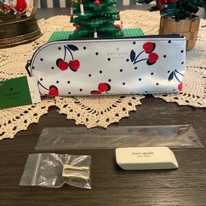 This is a Kate Spade New York cherry-print pencil case set.